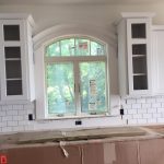 Trim around a window between cabinets built and installed by our finish carpenters.