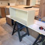 built in a bar with lighted liquor shelves of stone, granite and barnwood