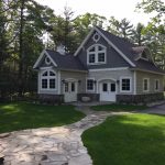 A carriage house garage with living quarters above and extra storage.