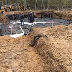 Installing drainage under foundation, these pipes will be buried in 10 inch of pea stone.